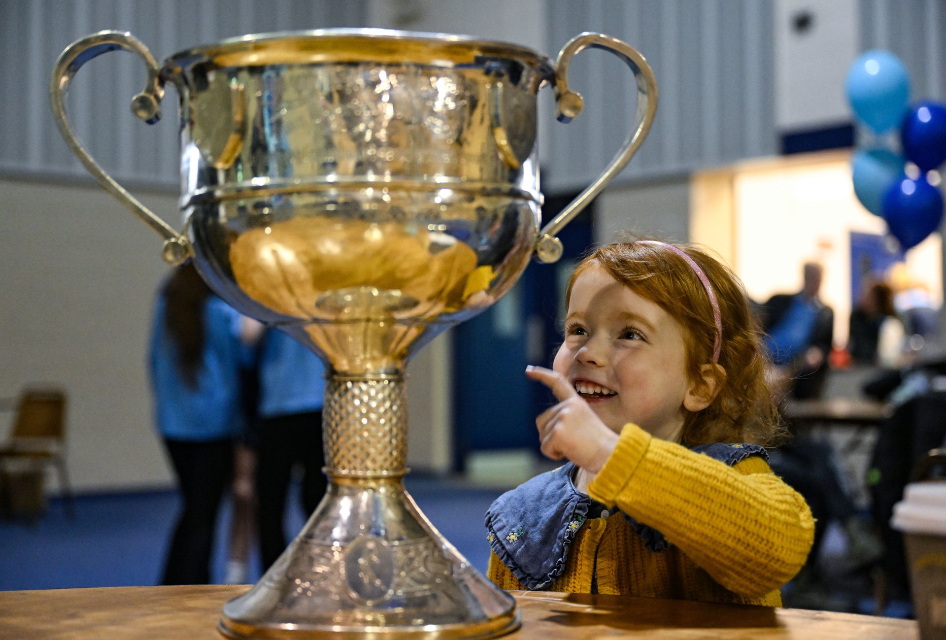 LGFA Yearbook Launch: A young Dublin fan admires the Brendan Martin cup. Credit Sportsfile.  Image